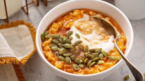 Bowl of Homemade Pumpkin Oatmeal Porridge with Seeds and Yogurt