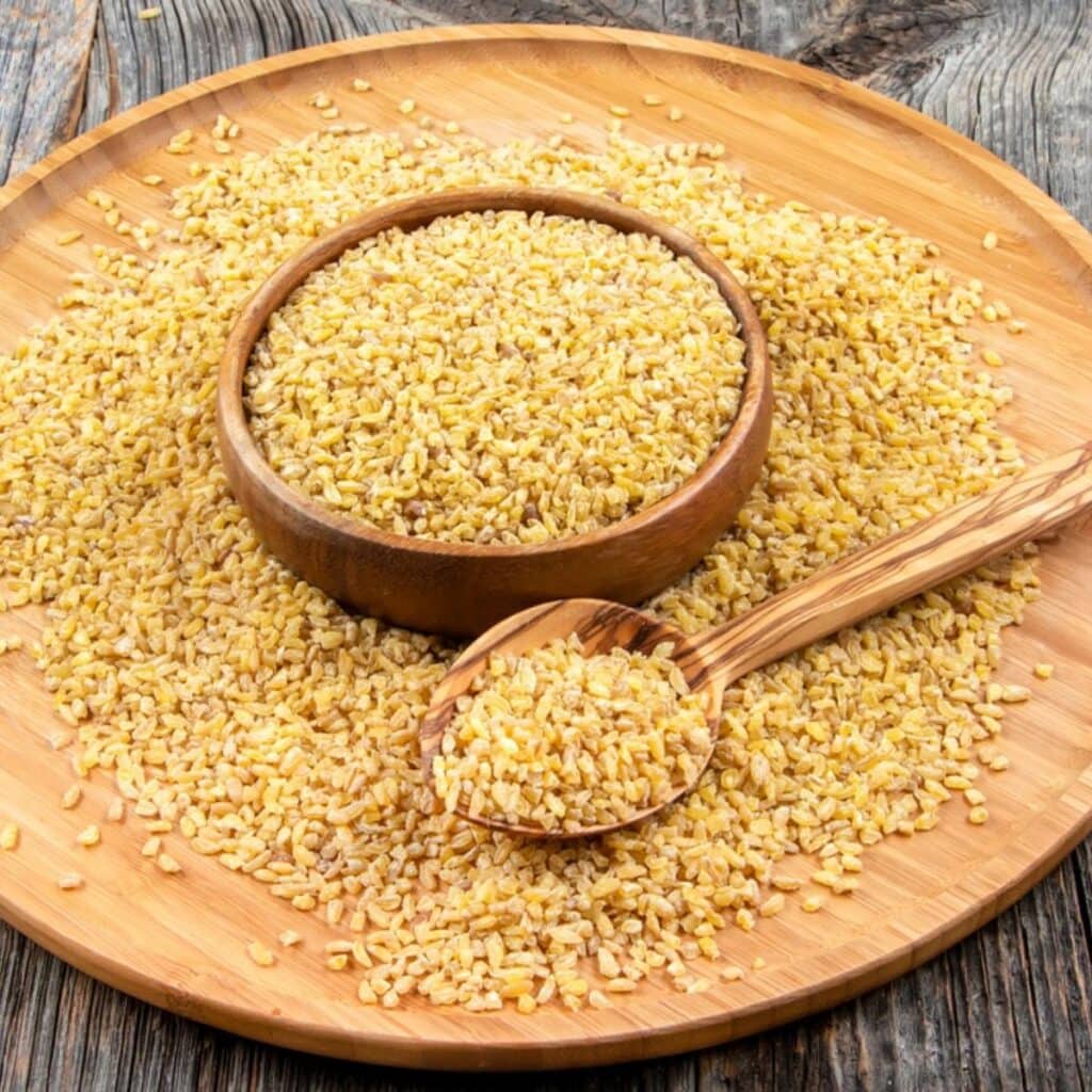 Bulgur Wheat in a bowl and spilled over onto a board