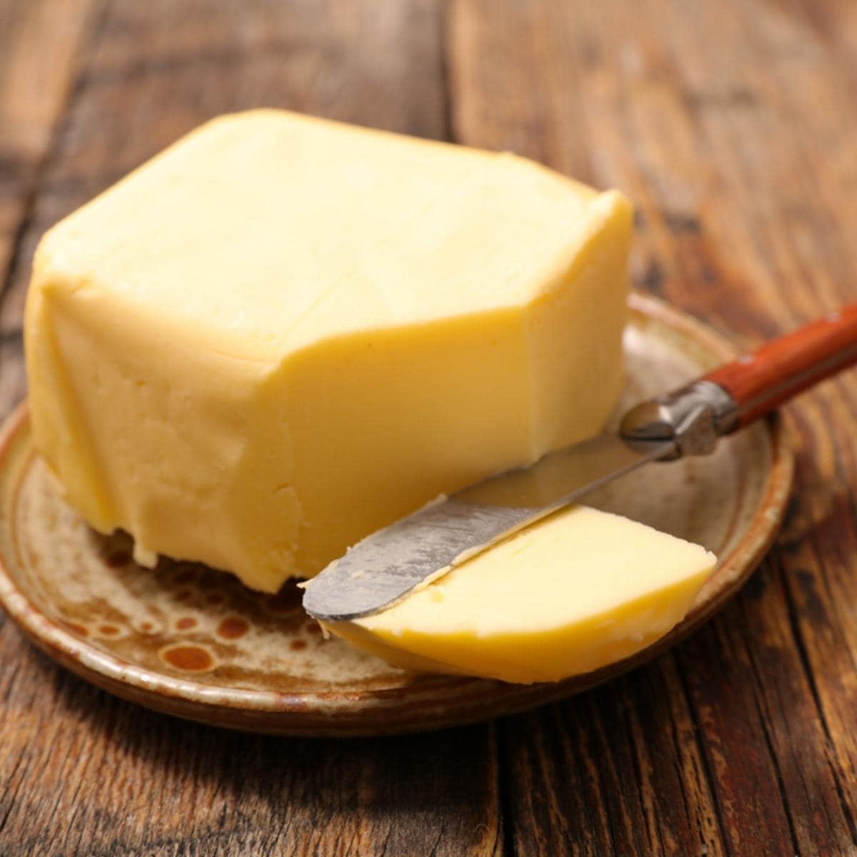Cube of Butter on a Wooden Plate
