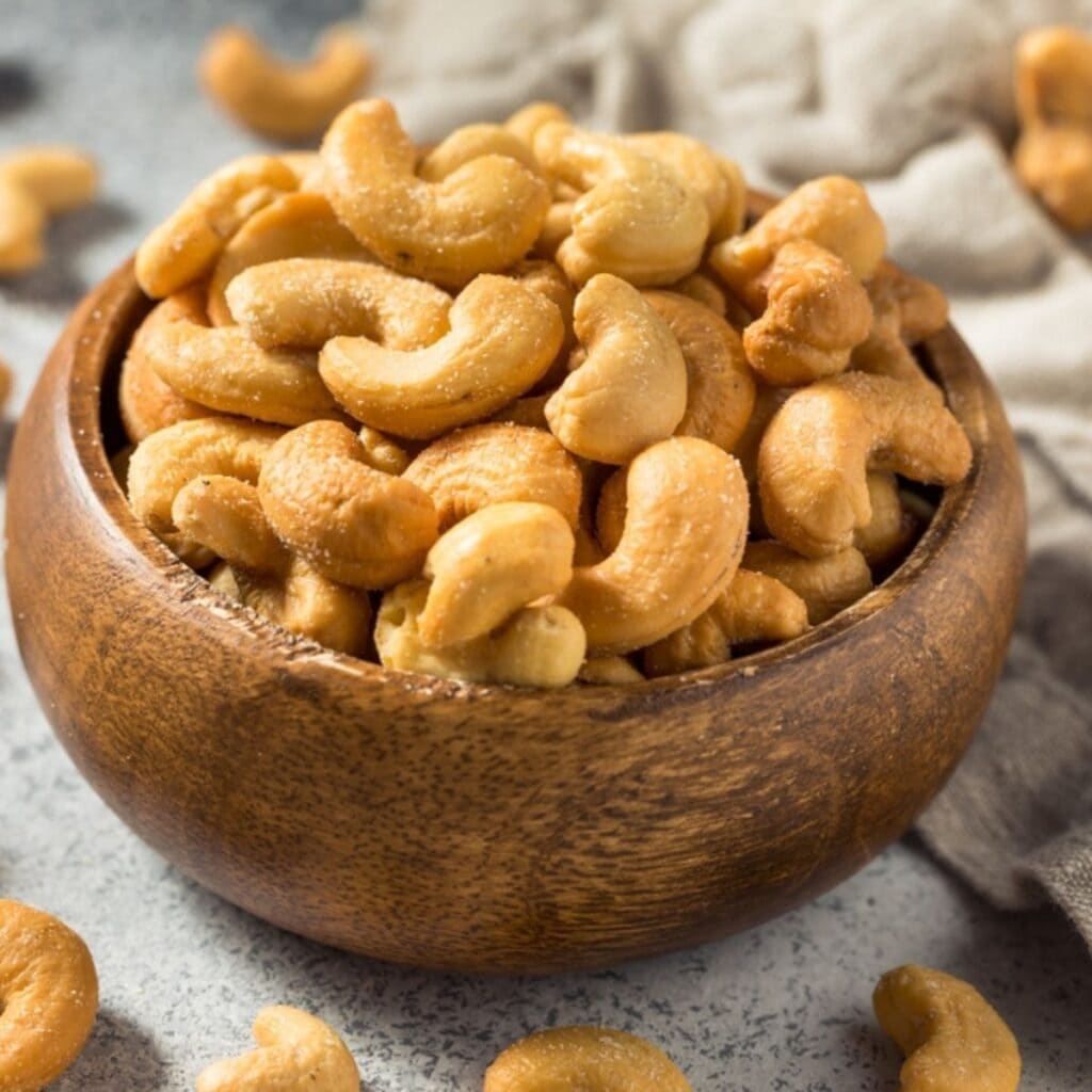 Small Wooden Bowl Full of Cashew Nuts