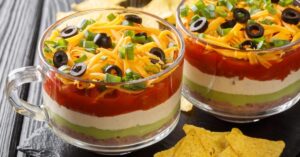 Classic Seven Layer Taco Dip with Refried Beans, Guacamole and Salsa