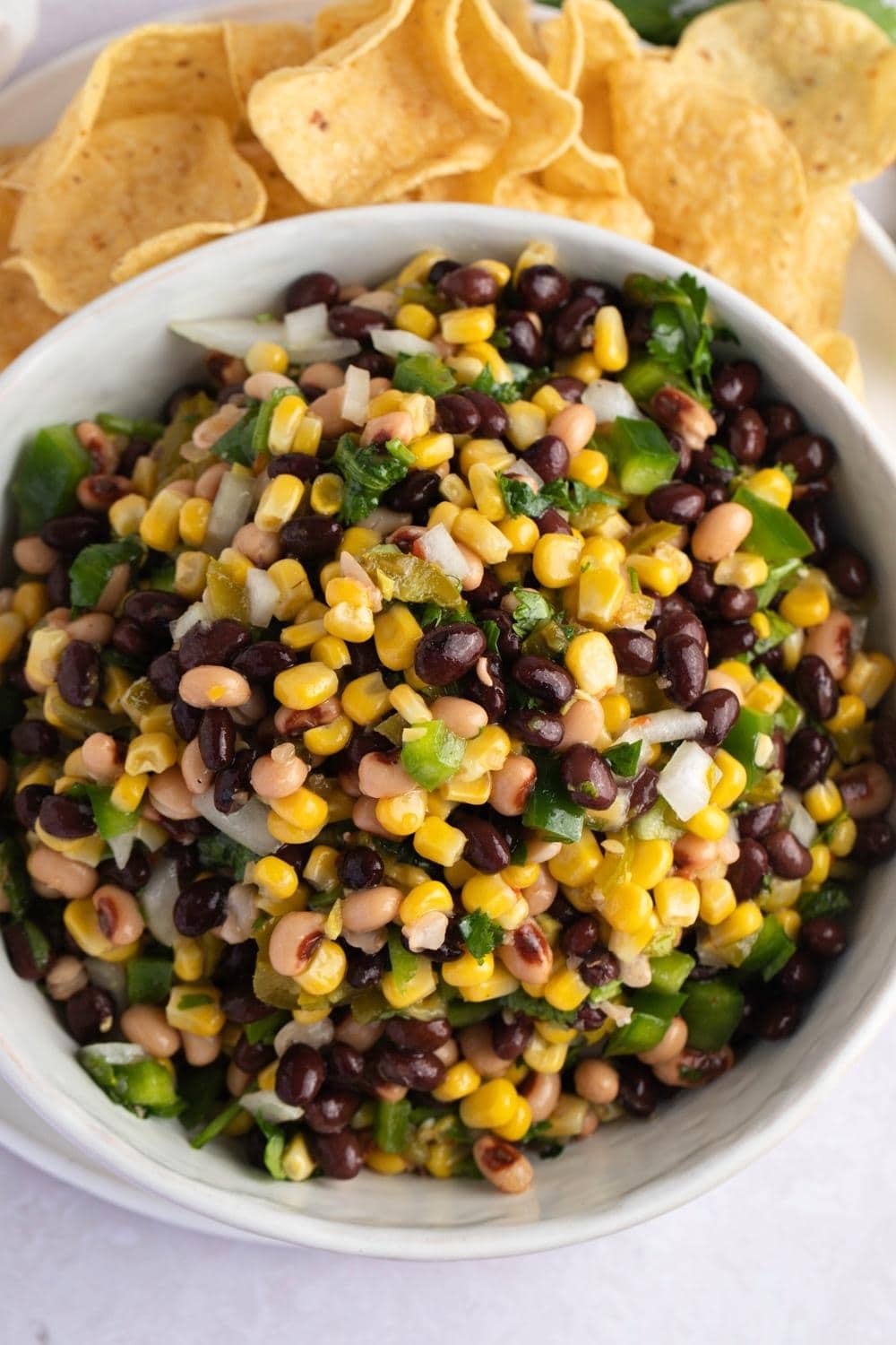 Bowl of Cowboy Caviar salad made with beans, pepper and corns. 
