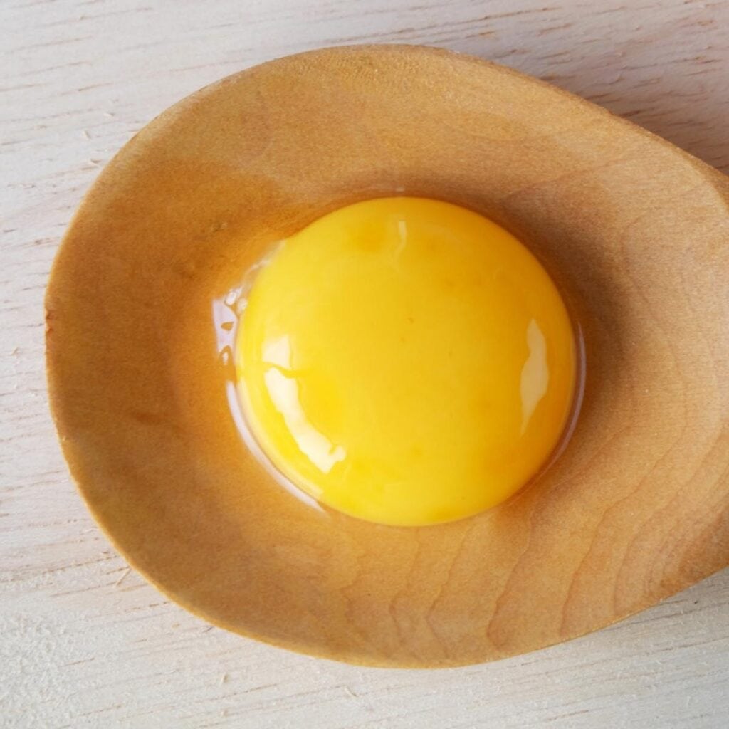 Egg Yolk on a Wooden Spoon