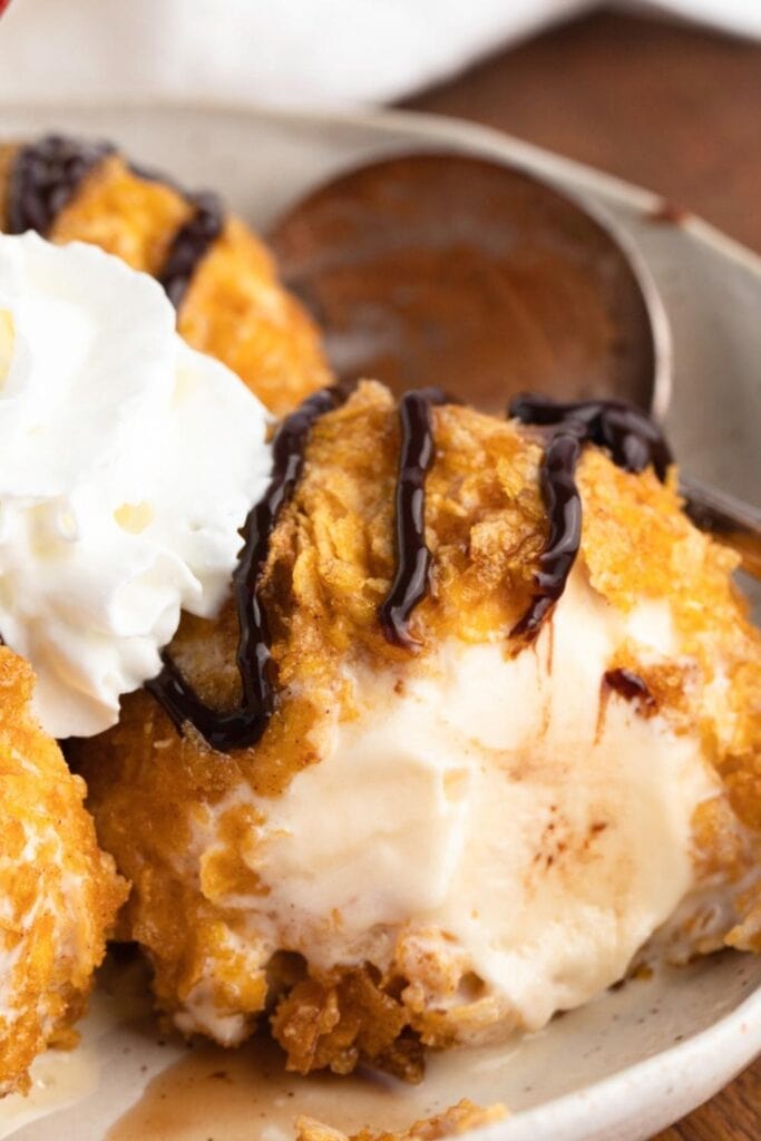 Close up of Creamy Fried Ice Cream with chocolate sauce and whipped cream