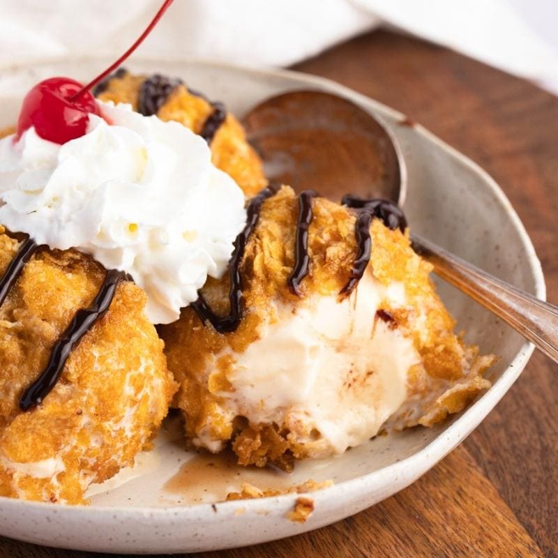 Fried Ice Cream with Chocolate Drizzle, Whipped Cream and Cherry