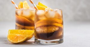 Glass of Cold Brew Bourbon Cocktail with Fresh Oranges