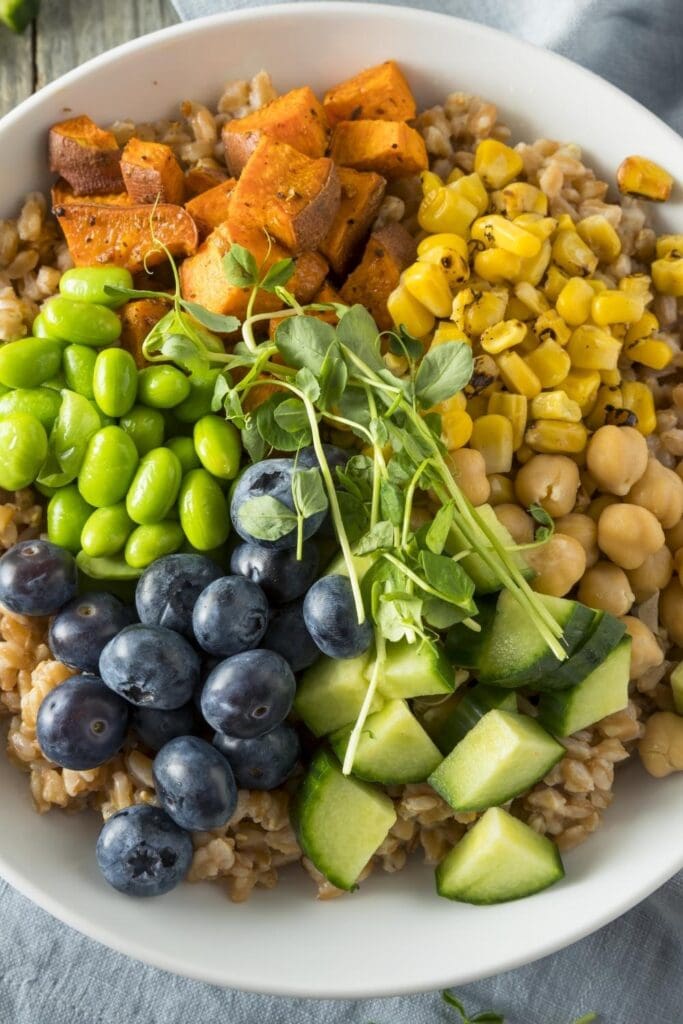 Healthy Buddha Bowl with Farro, Sweet Potatoes, Blueberries and Cucumber