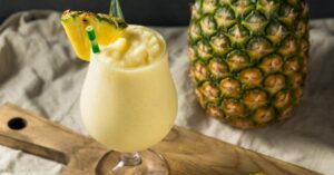 Homemade Boozy Pina Colada with Fresh Pineapple Slice