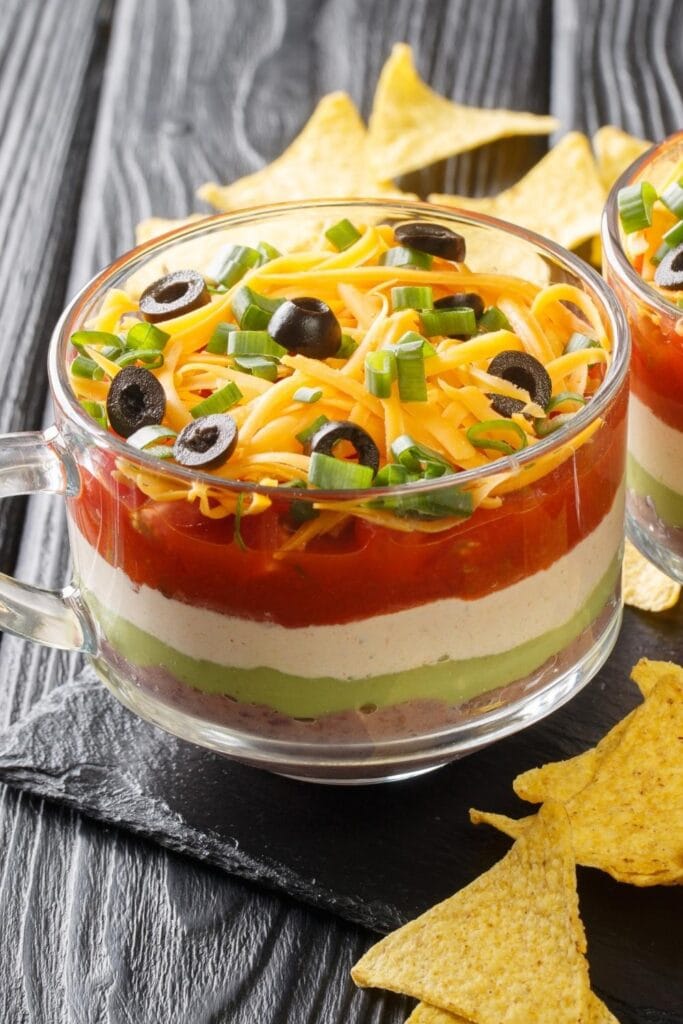 Homemade Seven Layer Taco Dip with Refried Beans, Guacamole, Cheese and Salsa