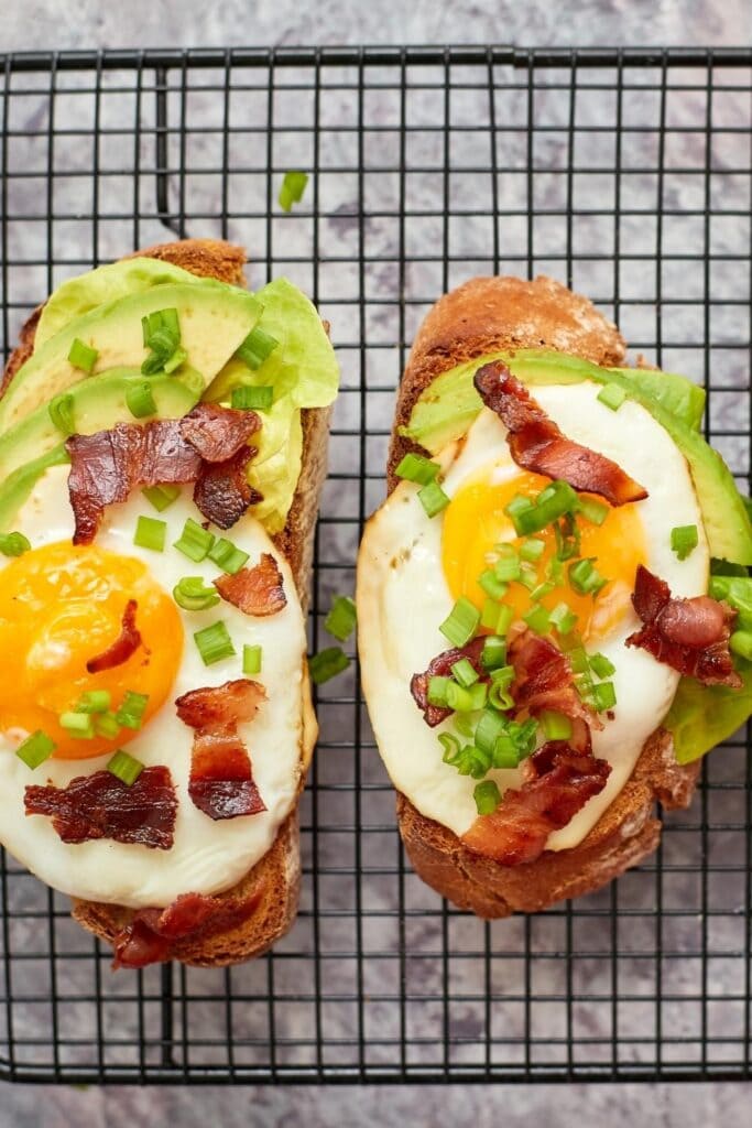 Homemade grilled sandwich with egg, bacon and avocados