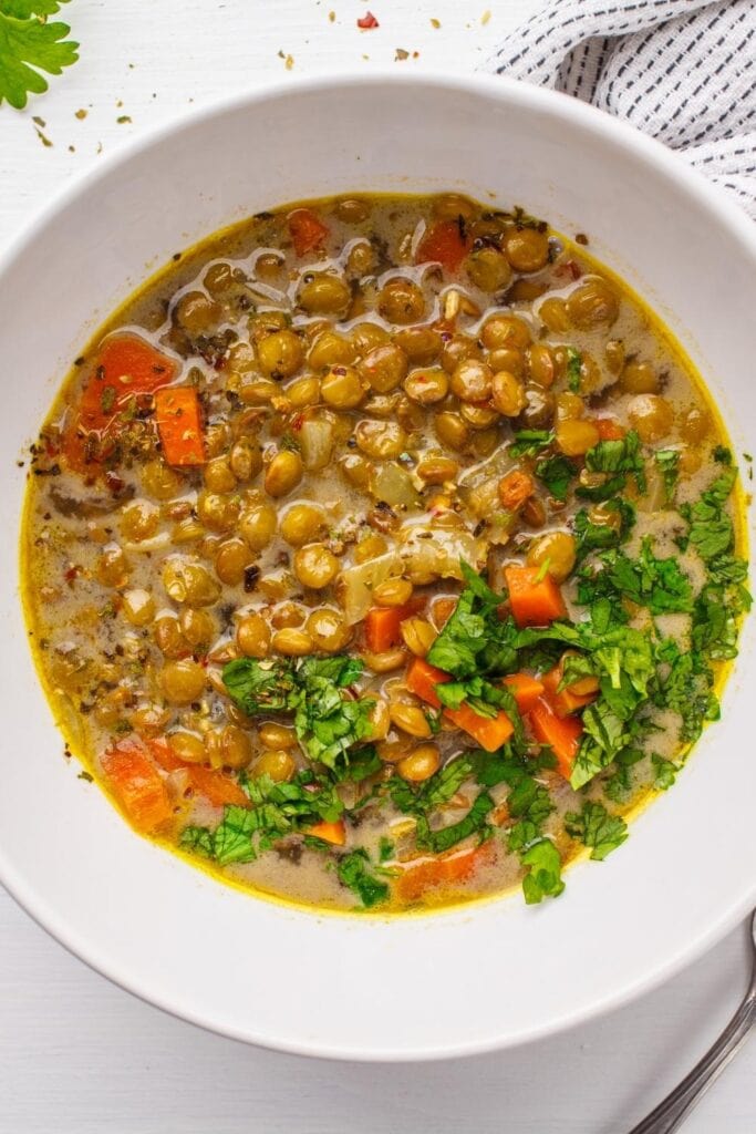 Homemade Vegan Lentil Soup with Greens and Carrots in a Bowl