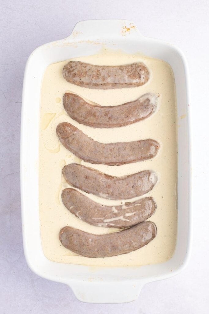 Pork Sausages Soaked with Batter in a Baking Dish