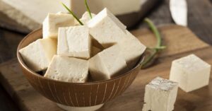 Raw Organic Soy Tofu Cubes in a Wooden Bowl