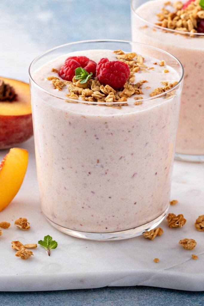 Peach and Strawberry Smoothie with Granola and Fresh Berries
