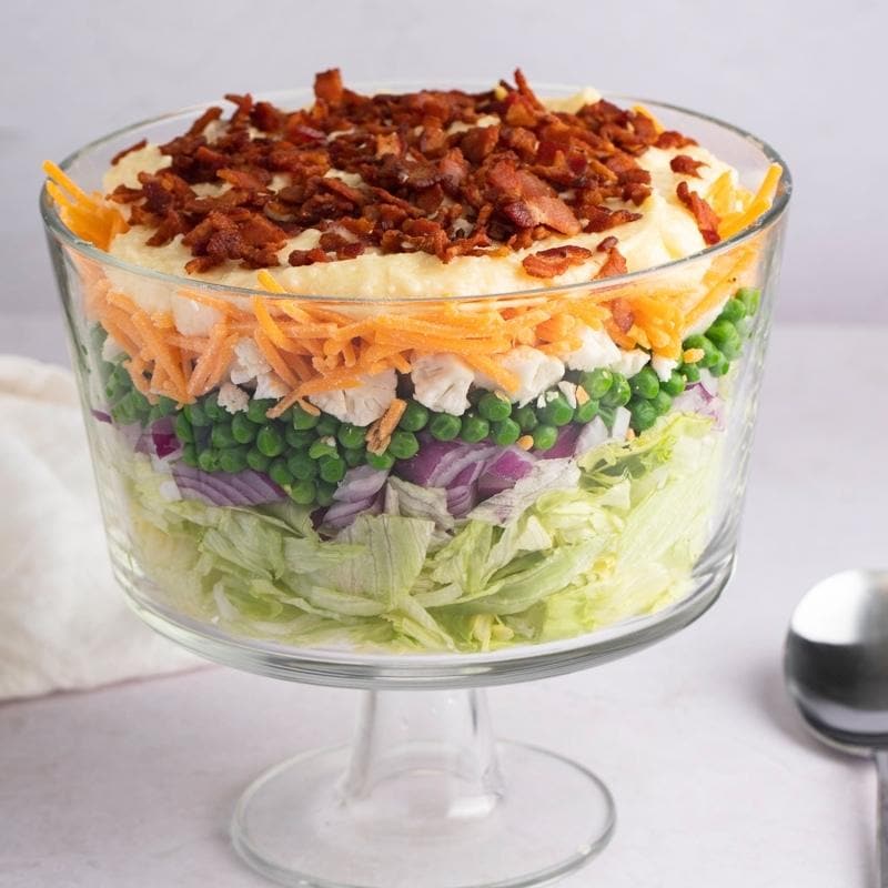 Seven Layer Salad in a Clear Glass Bowl 