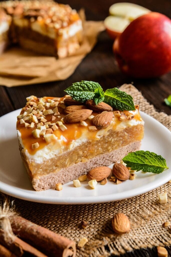 Sliced ​​apple cake topped with caramel and almonds