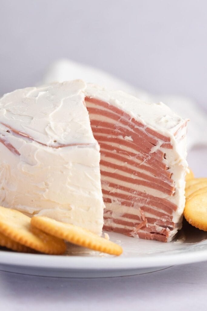 Bologna Cake Covered with Cream Cheese Frosting and crackers
