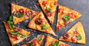 Sliced Healthy Homemade Pizza, Tomatoes, Mozzarella and Basil