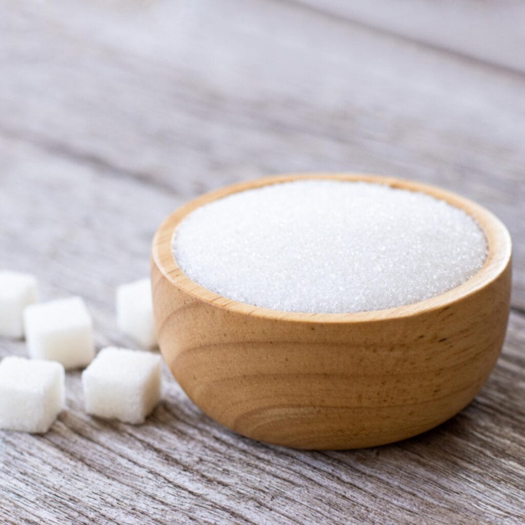 White Sugar on a Wooden Bowl