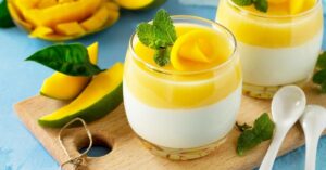 Sweet Homemade Mango Panna Cotta with Mint in a Wooden Board