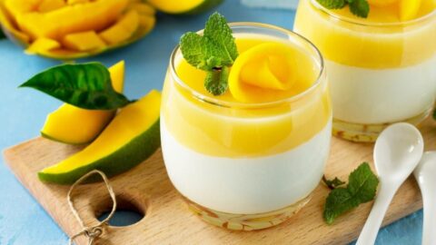 Sweet Homemade Mango Panna Cotta with Mint in a Wooden Board