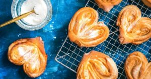 Sweet Homemade Palmier Cookies in a Baking Rack with Powdered Sugar