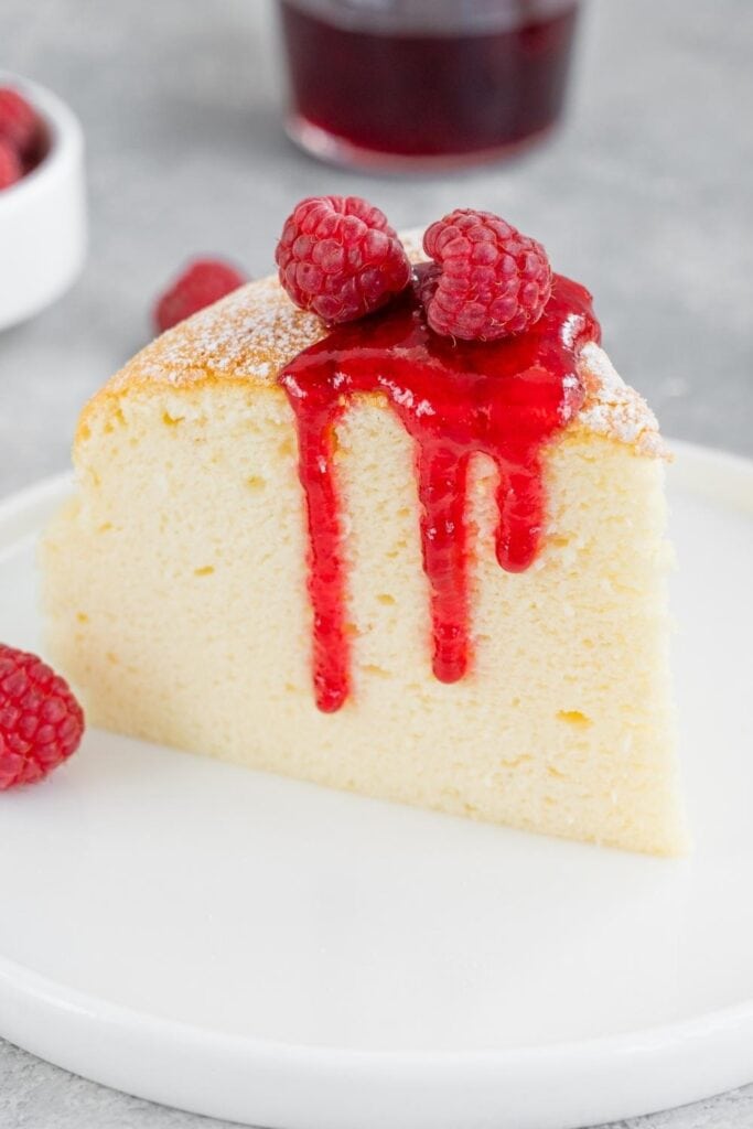 Sweet Japanese Cotton Cheesecake with Powdered Sugar, Raspberries and Sauce