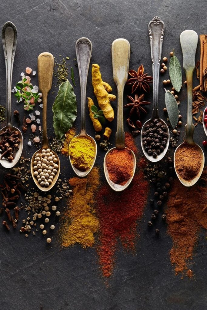 A Variety of Herbs and Spices Including Ground Ginger, Paprika, White and Black Peppers