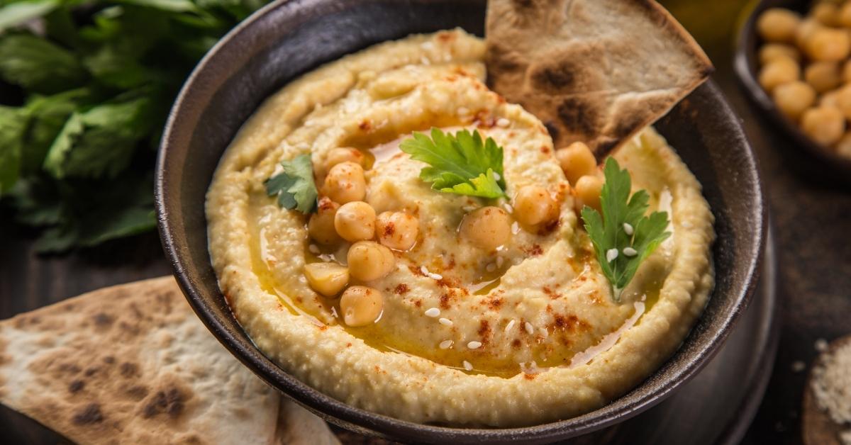 Appetizing Homemade Chickpea Hummus with Olive Oil and Bread