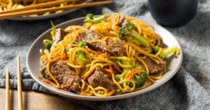 Beef Lo Mein with Beef and Broccoli in a White Plate