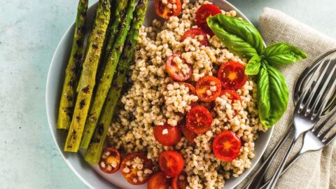 Bowl of Healthy Salad with Asparagus, Tomatoes and Sorghum