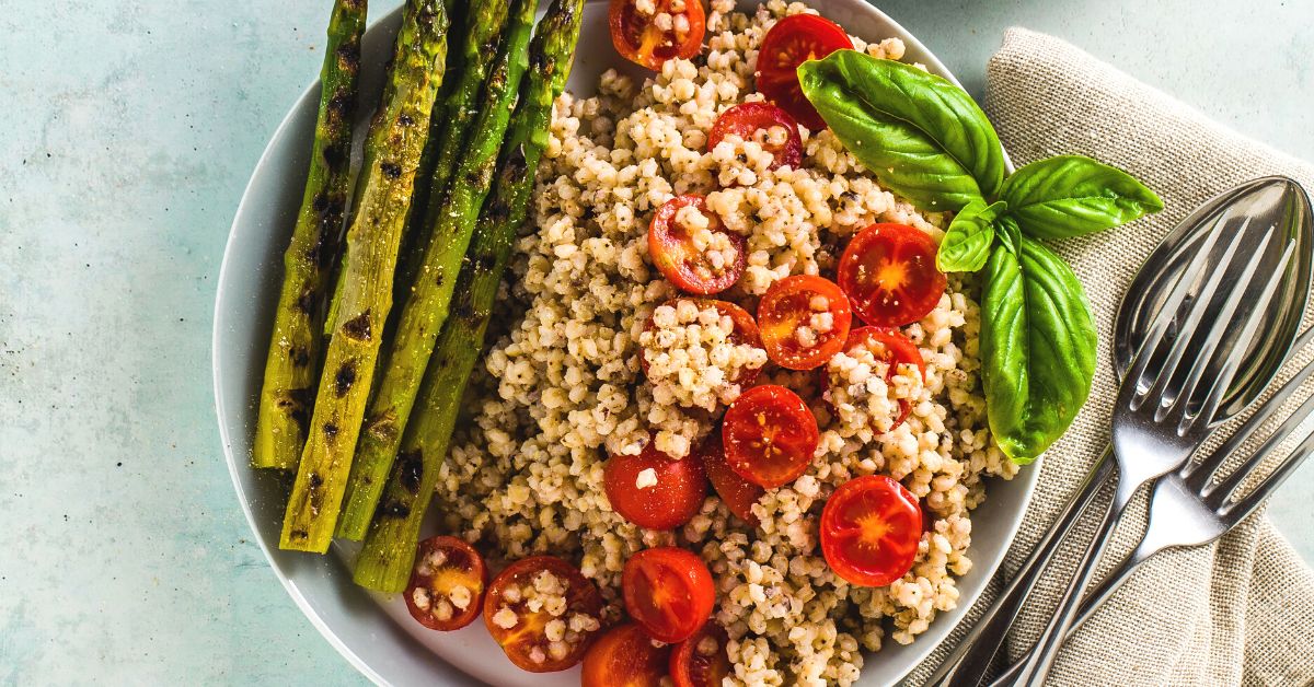 Bowl of Healthy Salad with Asparagus, Tomatoes and Sorghum