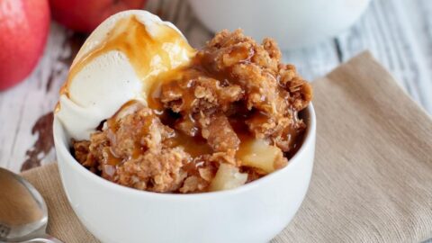 Bowl of Homemade Apple Crisp with Ice Cream and Caramel Sauce