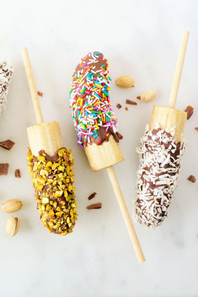 Chocolate Dipped Banana Pops with Sprinkled Candies, Nuts and Coconut