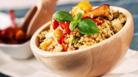 Couscous Salad with Meat and Vegetables in a Wooden Bowl