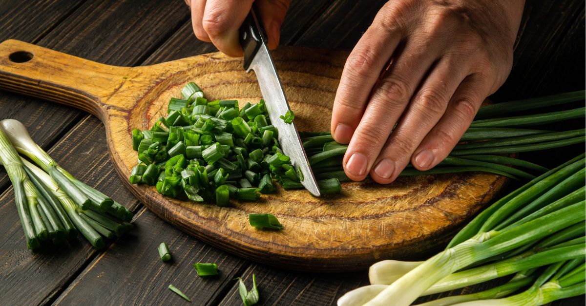 Green Onions Chopped in a Wooden Cutting Board