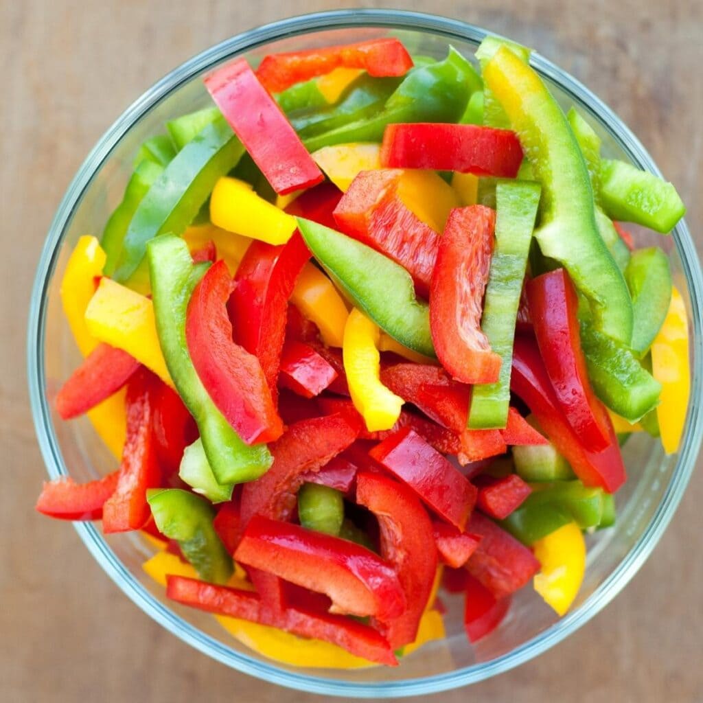 Green, Yellow and Red Pepper Slices in a bowl
