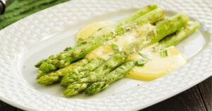 Grilled Asparagus with Hollandaise Sauce in a White Plate