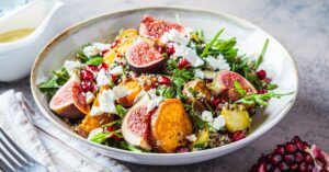 Healthy Homemade Salad with Pomegranate, Cheese, Figs, Brussel Sprouts and Potatoes