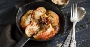 Homemade Caramelized Apple with Cinnamon in a Black Skillet
