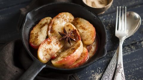 Homemade Caramelized Apple with Cinnamon in a Black Skillet