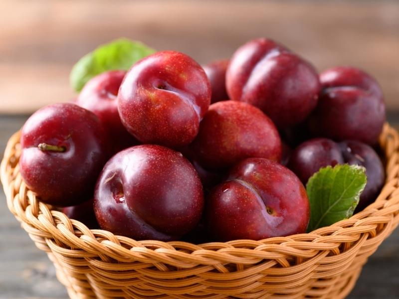 Japanese Plums (Chinese Plums) on a Wooden Basket