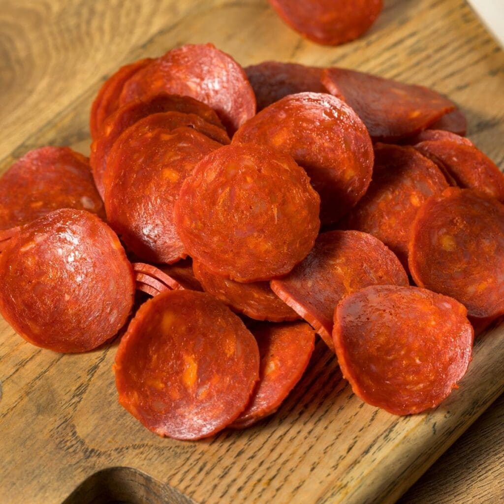 Pepperoni Slices in a Wooden Chopping Board
