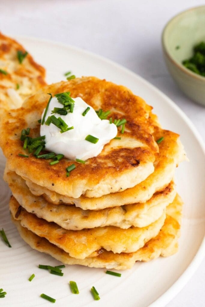 Potato Cakes With Sour Cream and Chives Garnish