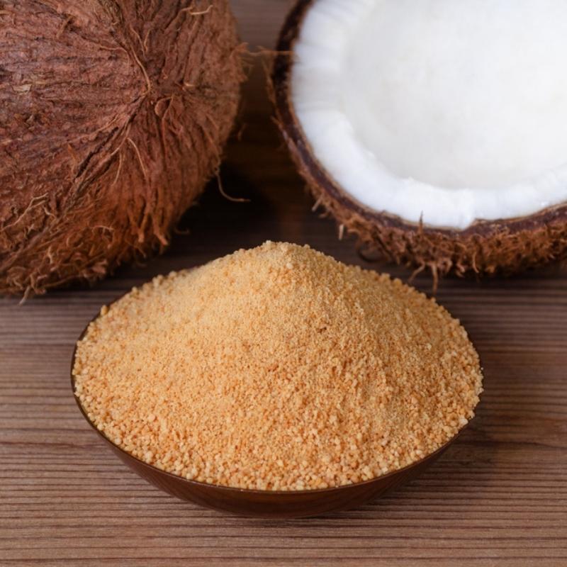 Fresh Coconut and Powdered Coconut Sugar in a Wooden Bowl