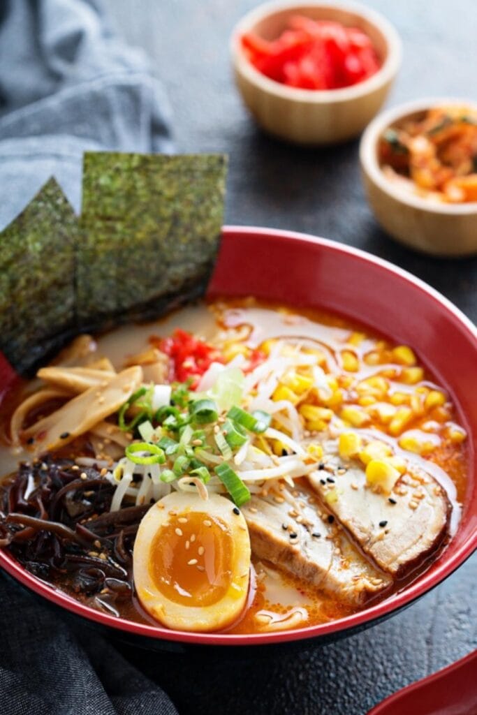 Bowl of Ramen Topped With Boiled Eggs and Pork
