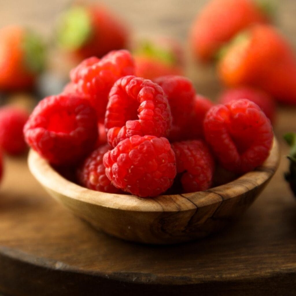 Wooden Bowl Filled with Raspberries