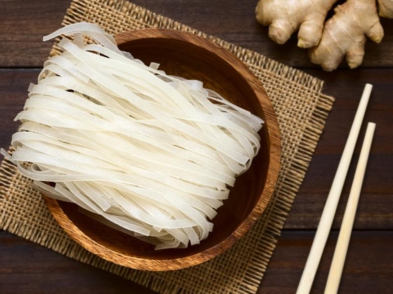 Raw Rice Noodles on a Wooden Bowl