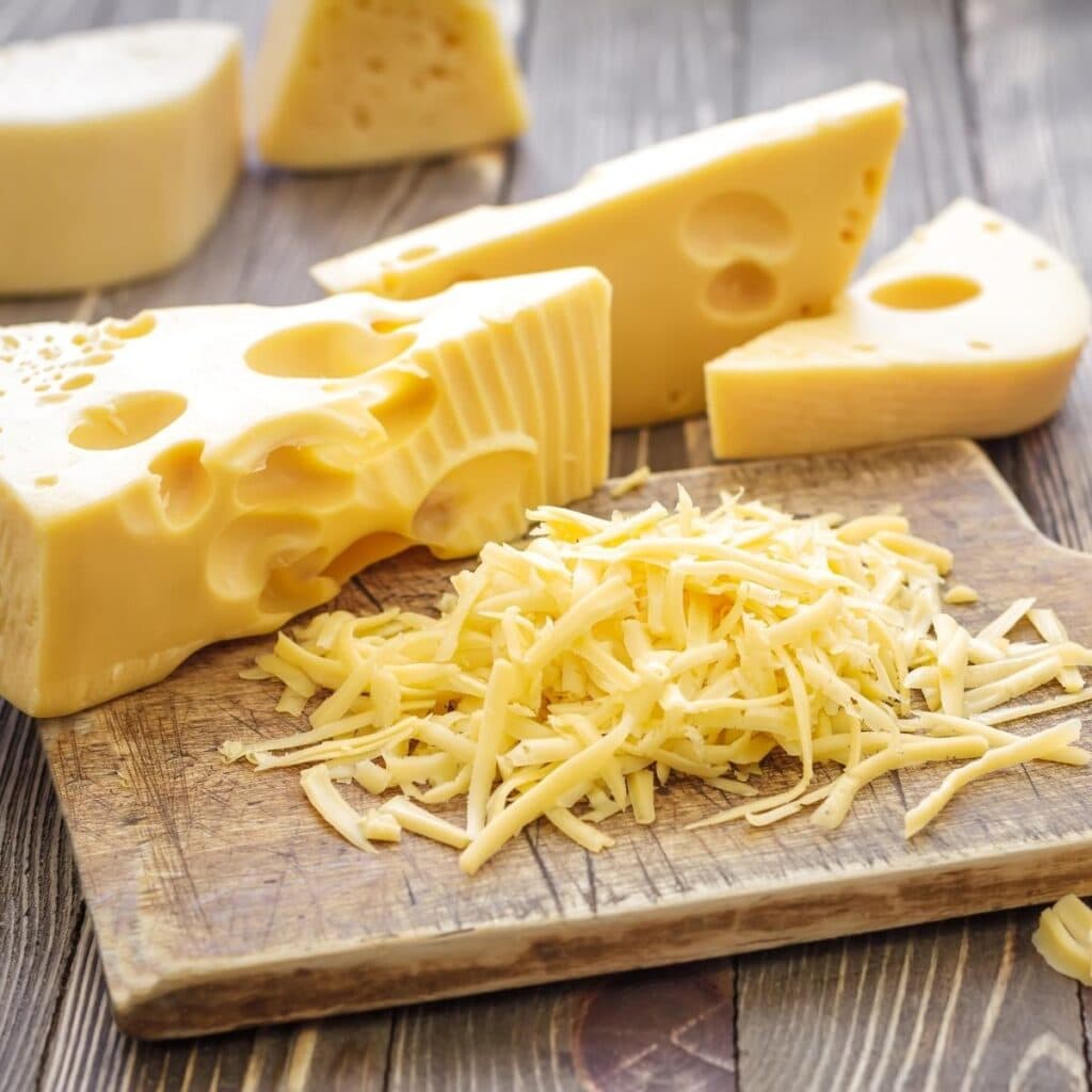 Shredded Cheese in a Wooden Chopping Board