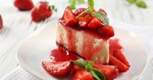 Slice of Sweet Homemade Strawberry Cheesecake with Sauce